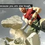 A person wearing a red and green outfit breaks large rocks with a sledgehammer under Seattle’s cloudy sky, embodying the grit of a true sports chiropractor. Subtitles read, "...because you are one tough. Sports Medicine Northwest - West Seattle Chiropractic Clinic