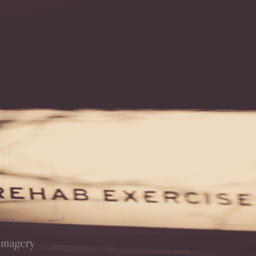 A blurred image of a sign reading "Corrective Exercise" is gently overshadowed, hinting at pathways to recovery. Sports Medicine Northwest - West Seattle Chiropractic Clinic